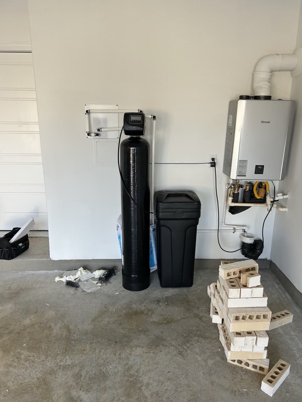 Single-tank softener beside a tankless water heater